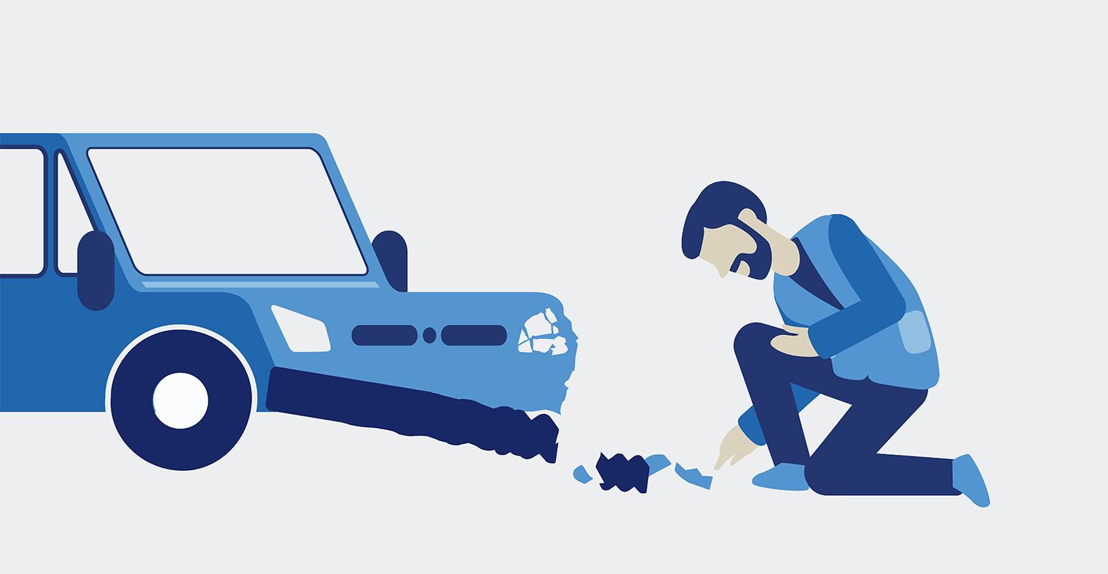 Mann kniet vor Auto und entdeckt Schaden